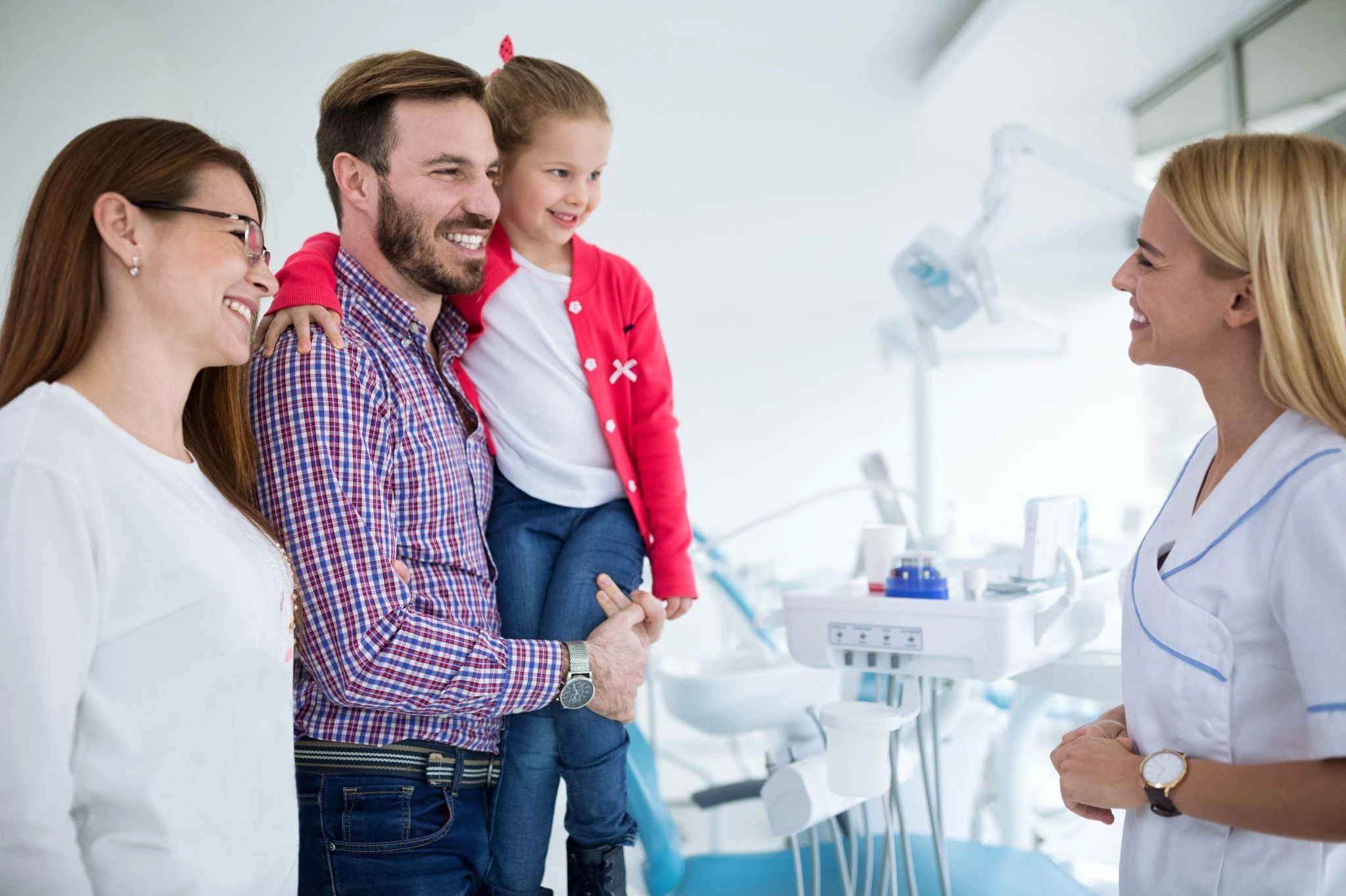 A family talking with a dental professional at a dental practice