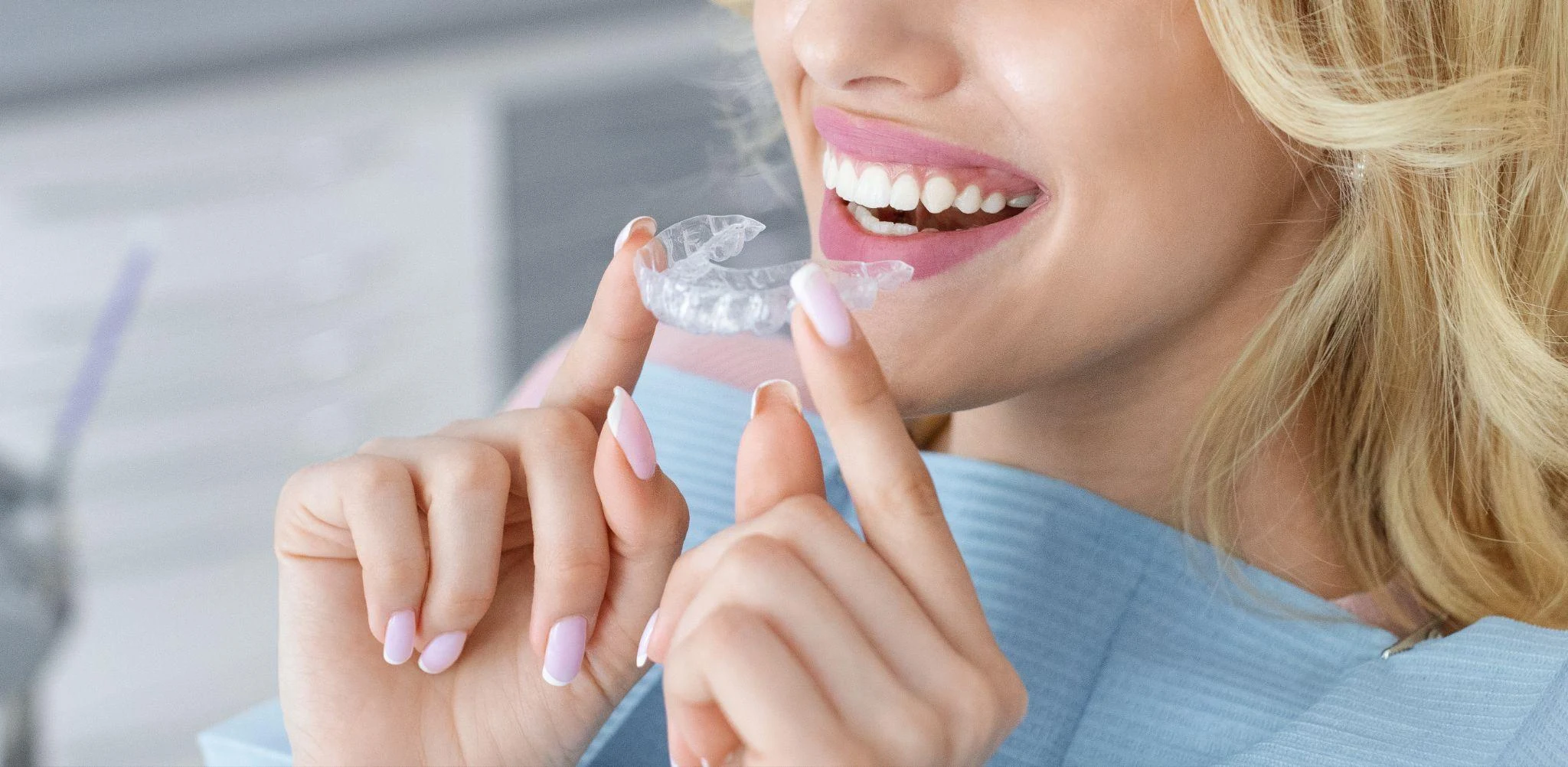 A patient holding removable clear aligners